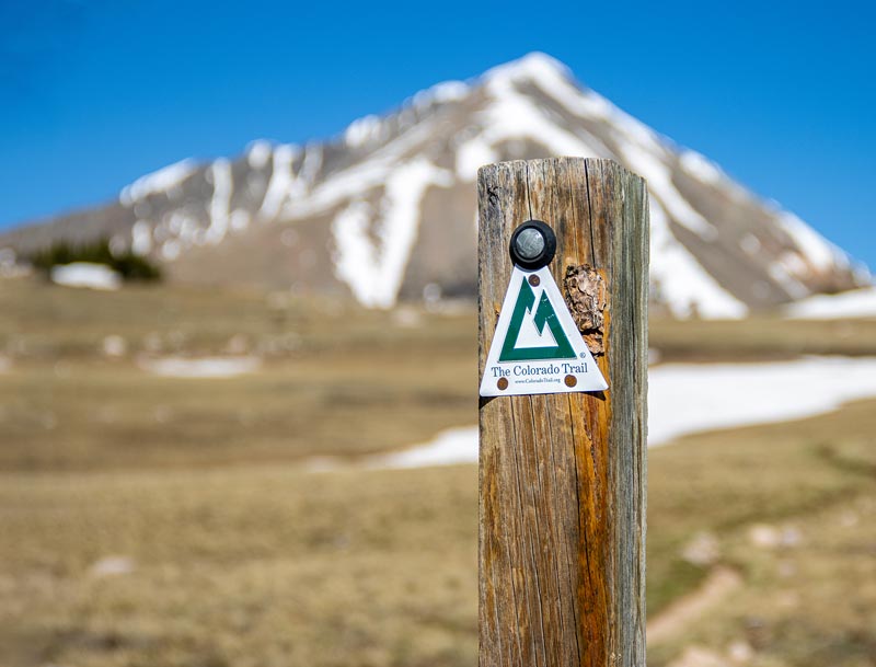 colorado trail marker with mountain in background